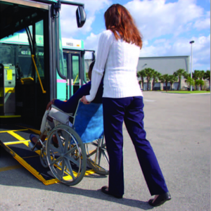 Wheelchair with people on bus ramp