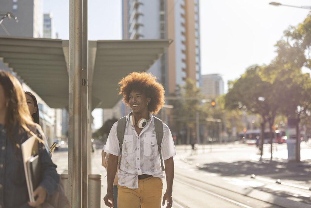 student man on his way to the train to go back to school