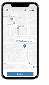 A smartphone displays a navigation app with a map view. The destination is 550-610 E Main St, highlighted by a blue pin. A “Confirm” button is at the bottom.
