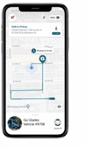Map on a smartphone showing a route with estimated pickup time of 4 minutes at an intersection. A bus labeled "Go Glades" is assigned.