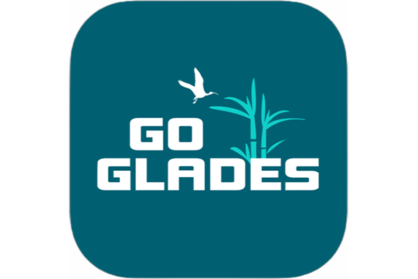 Logo depicting a white bird flying over tall grasses with the words "Go Glades" in bold white letters on a teal background. Conveys nature and exploration.
