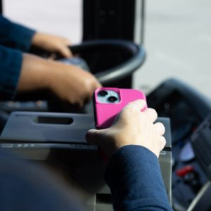 Smartphone being scanned by bus farebox.
