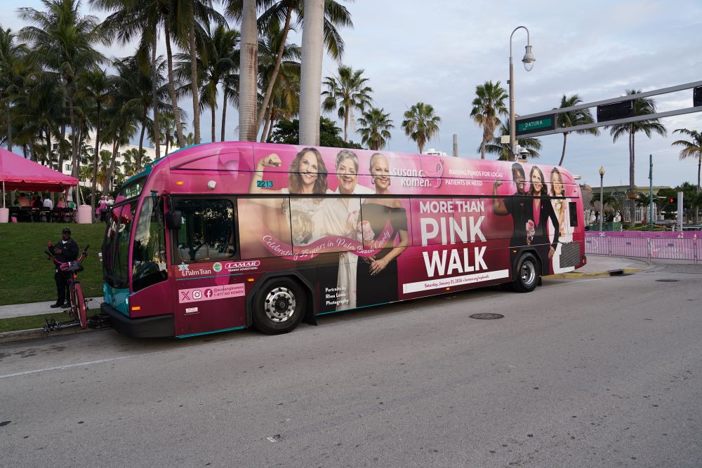Pink bus with images of women who were part of the Komen walk in West Palm Beach.